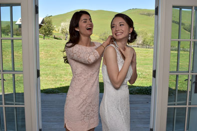D3400 features 100 years of Nikon know-how Photo of a woman putting a necklace on a bride's neck